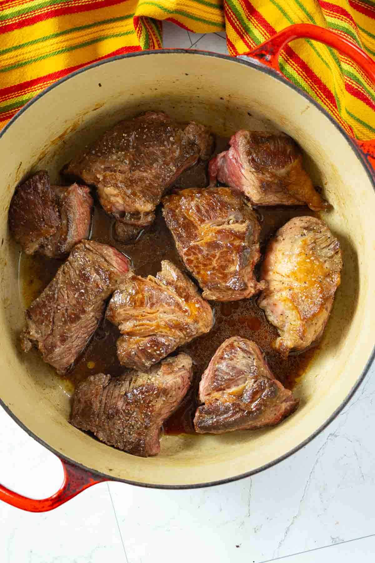 Placing pot roast into a Dutch oven to make Mexican Pot Roast - Step 5.