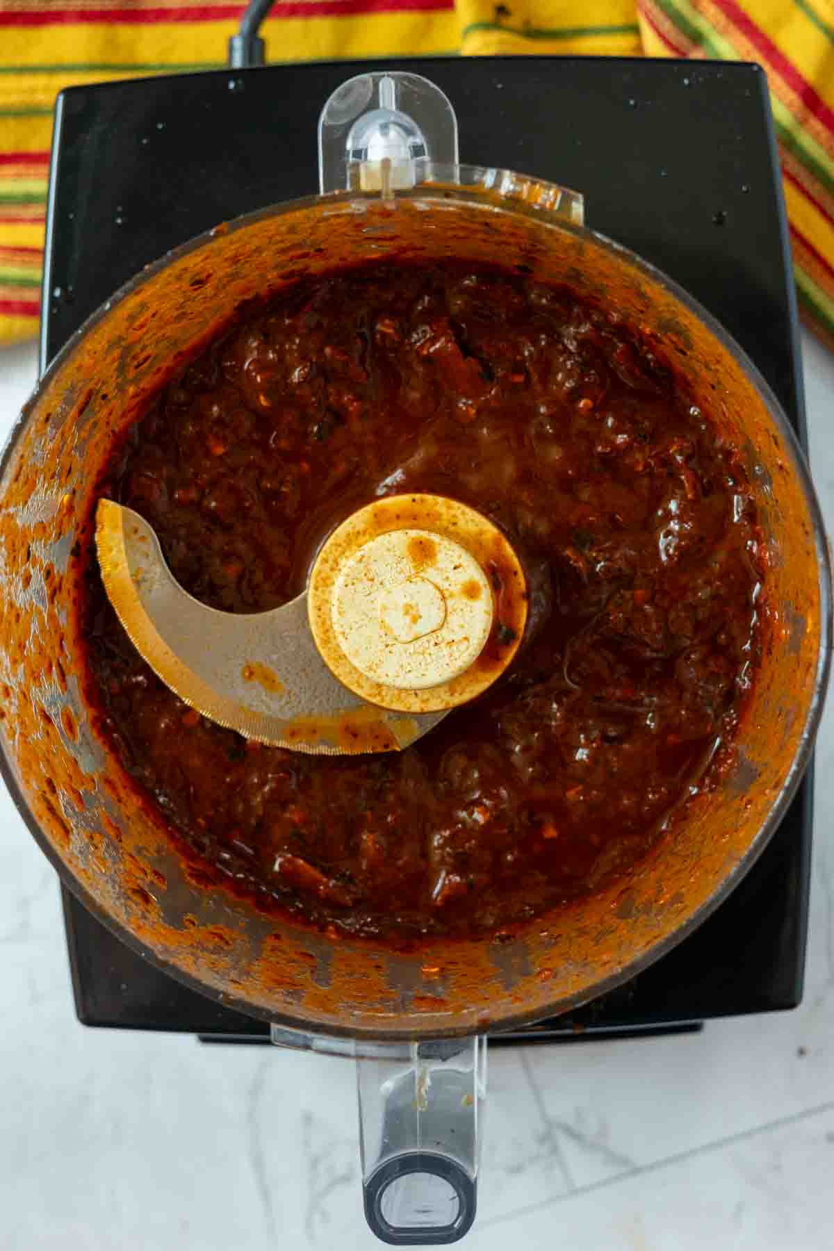 Grinding chile peppers in a food processor to make sauce for Mexican Pot Roast, Step 7.