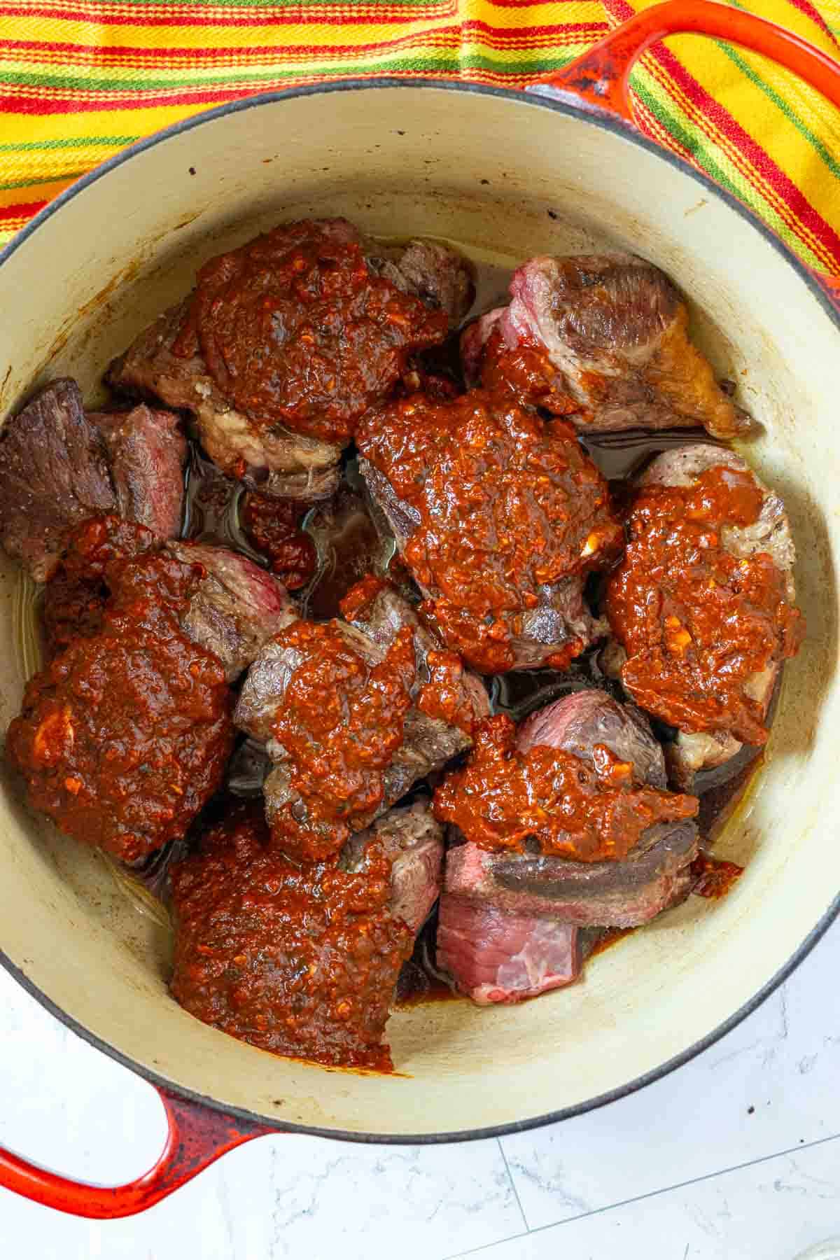 Chuck roast covered with Sauce to make Mexican Pot Roast.