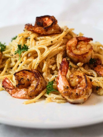 Spicy fried shrimp over pasta.