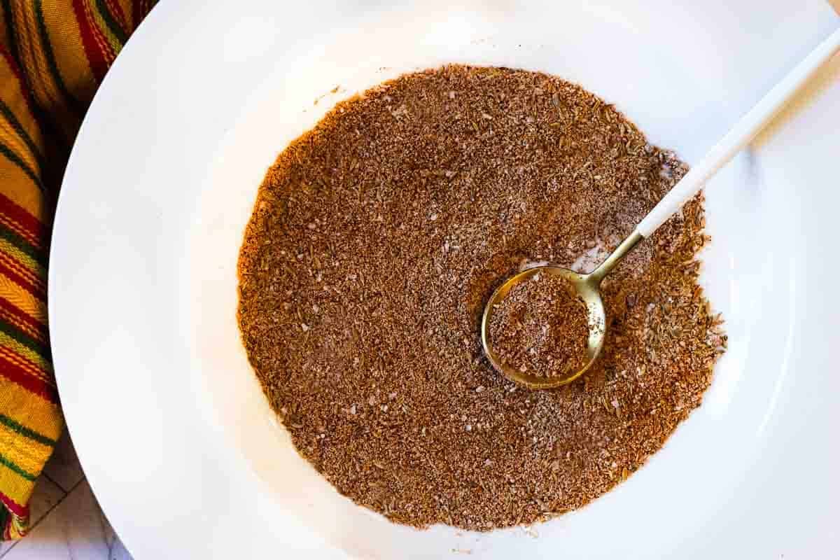 Homemade taco seasoning in a white bowl.