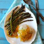 Chicken cordon bleu served with apricot sauce and asparagus.