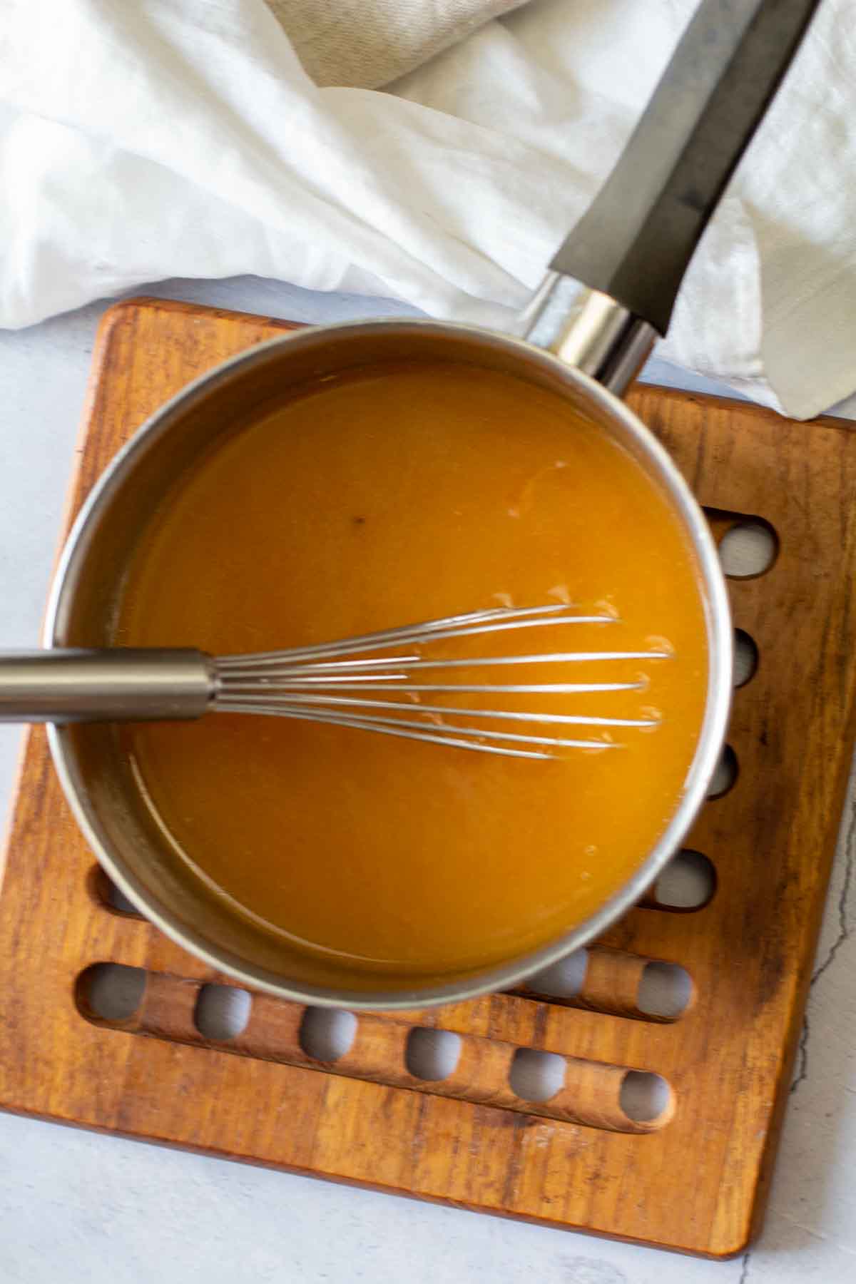 Cooking apricot brandy sauce for chicken cordon bleu.