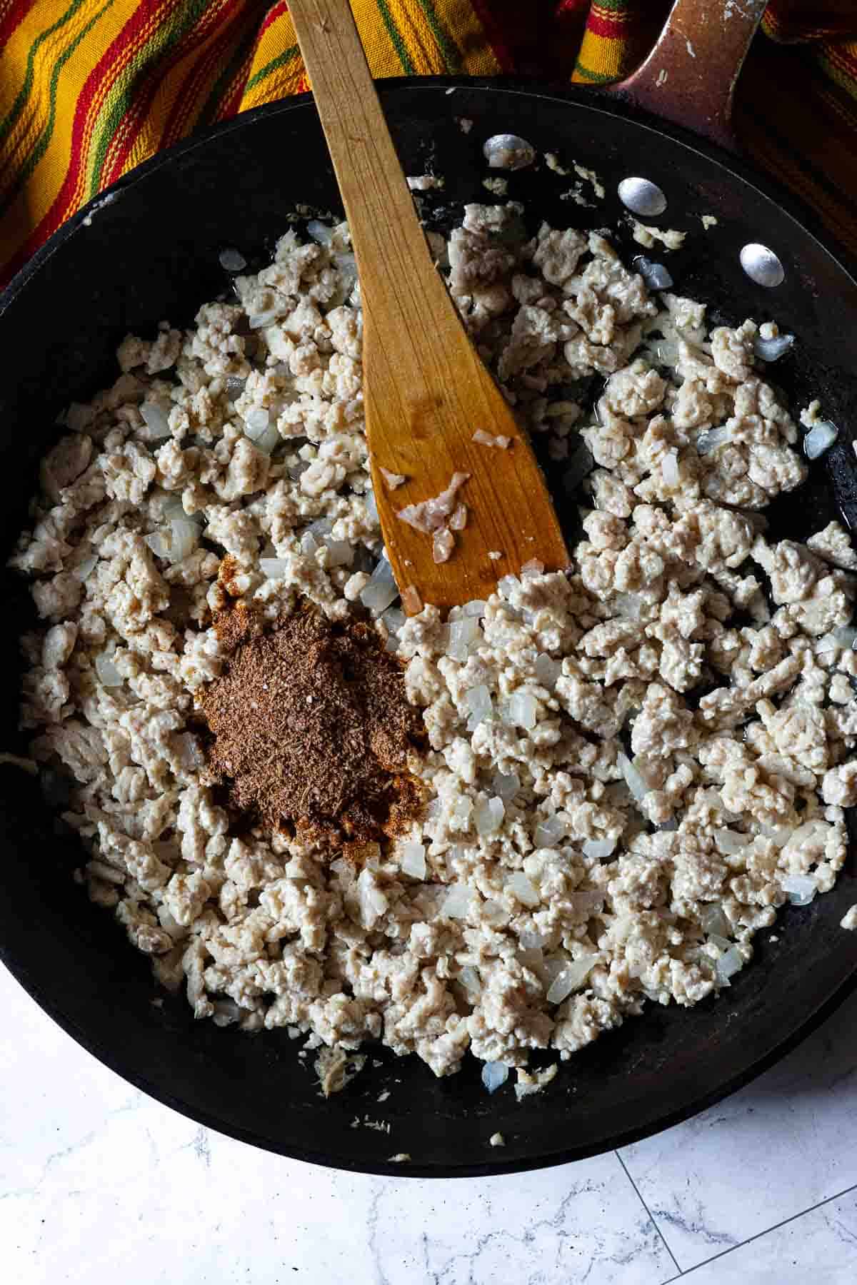 Browning meat in a skillet to make taco meat.