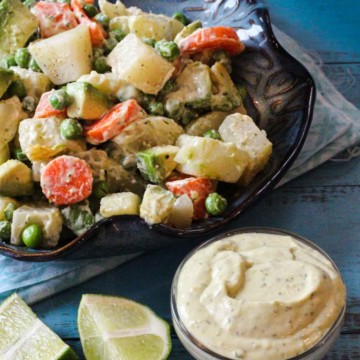 Avocado potato salad with carrots and peas.