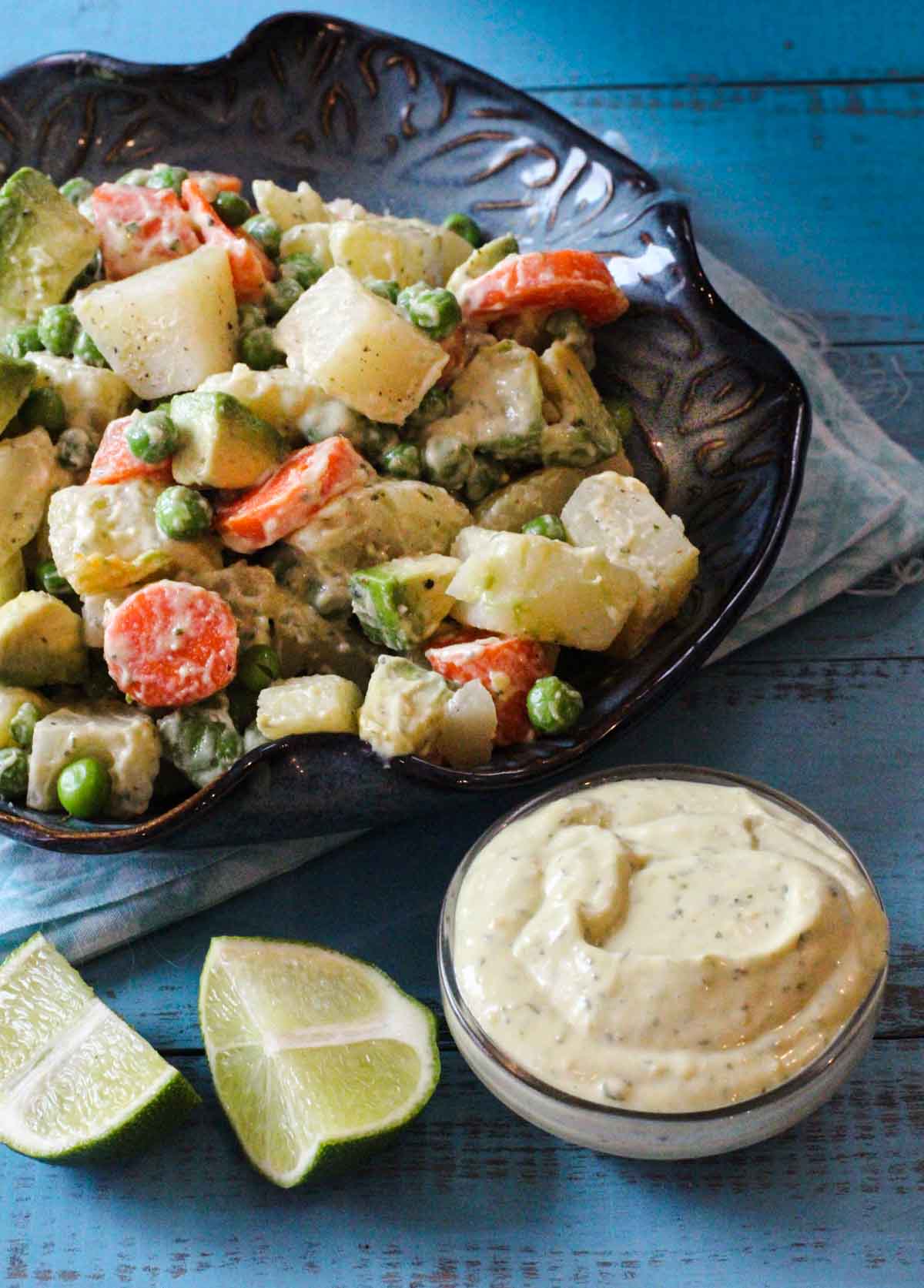 Avocado potato salad with carrots and peas.