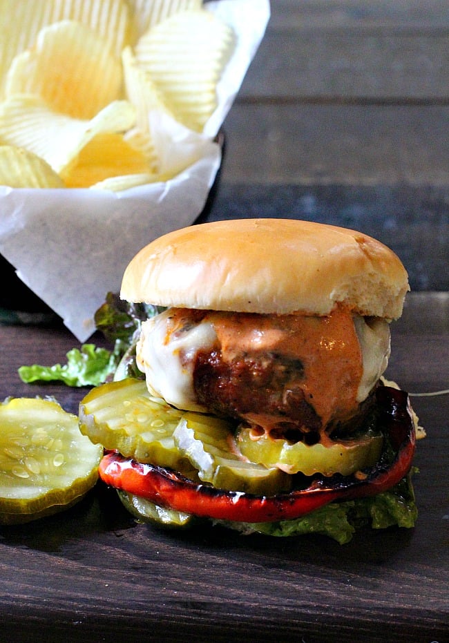 Buffalo Burger with Creamy Barbeque sauce on a bun with pickles. Best burger recipes for Father's Day