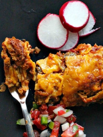 Mexican ground beef enchiladas with sliced radishes.