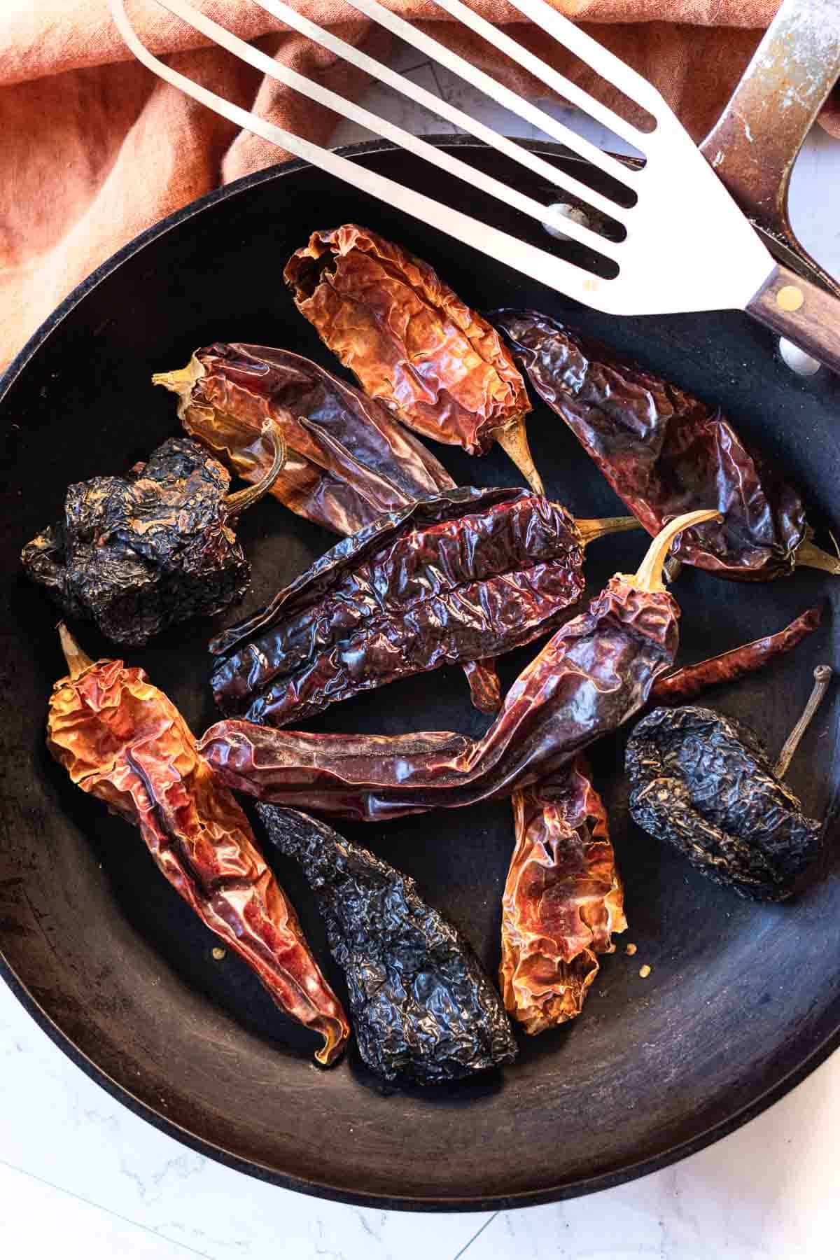 Step 1 red chile sauce for tamales, toasting dried chile pods.