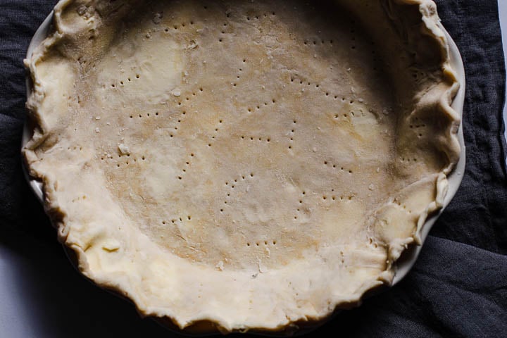 A homemade pie crust that's been docked with a fork.