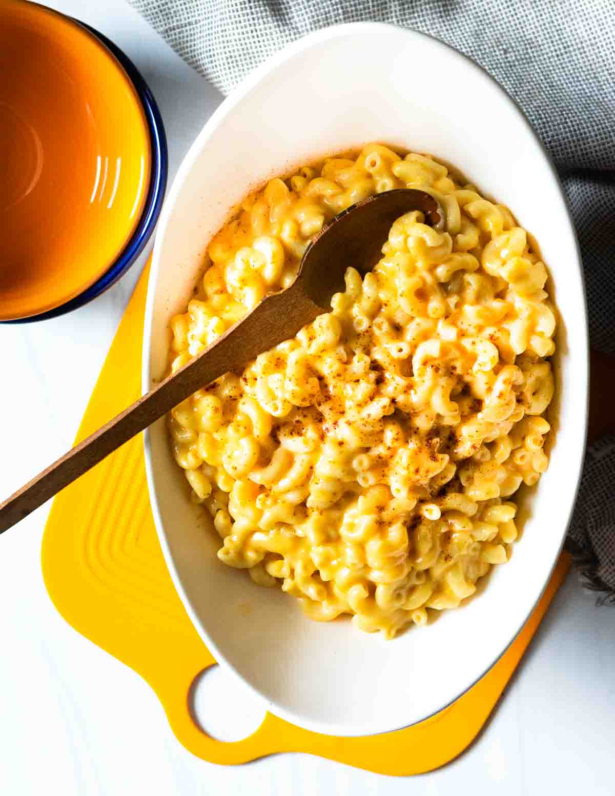 Beer mac and cheese in a white oval serving bowl.