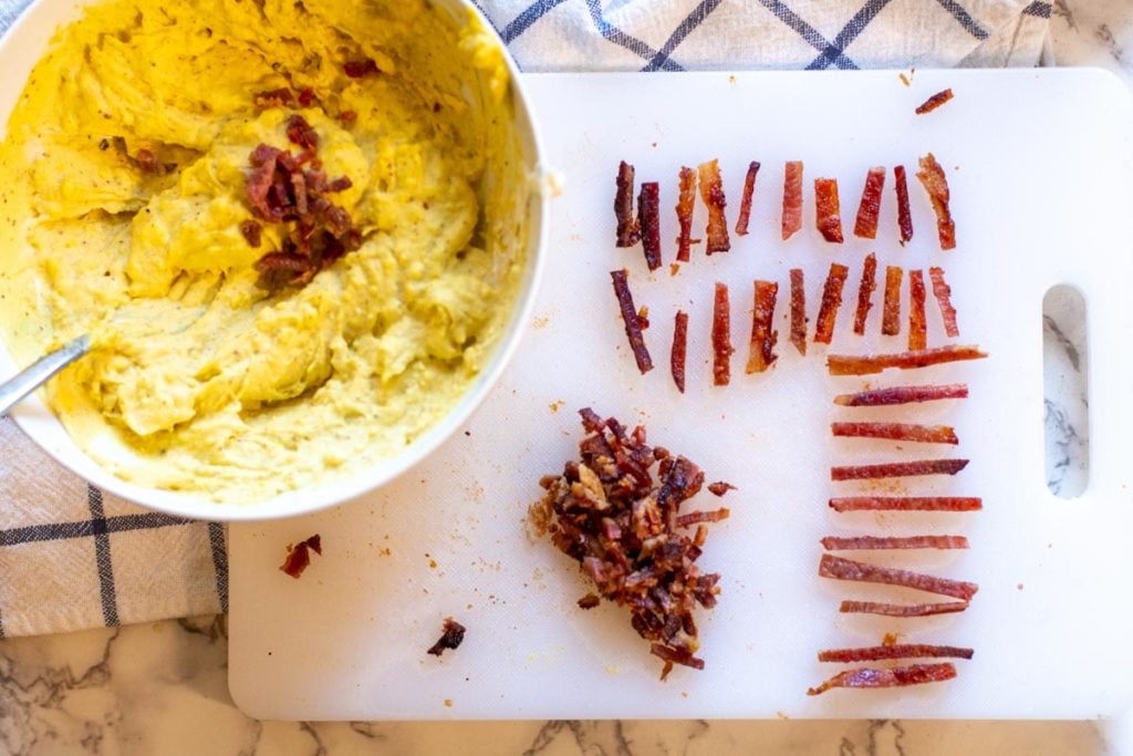slicing bacon to make football deviled eggs
