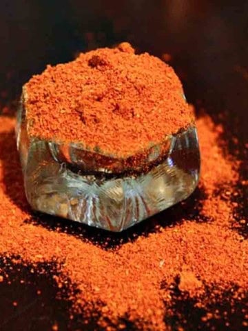 New Mexico Chimayo Red Chile Powder in a small glass container.