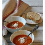 Creamy tomato soup with fire roasted tomatoes topped with grated cheese.