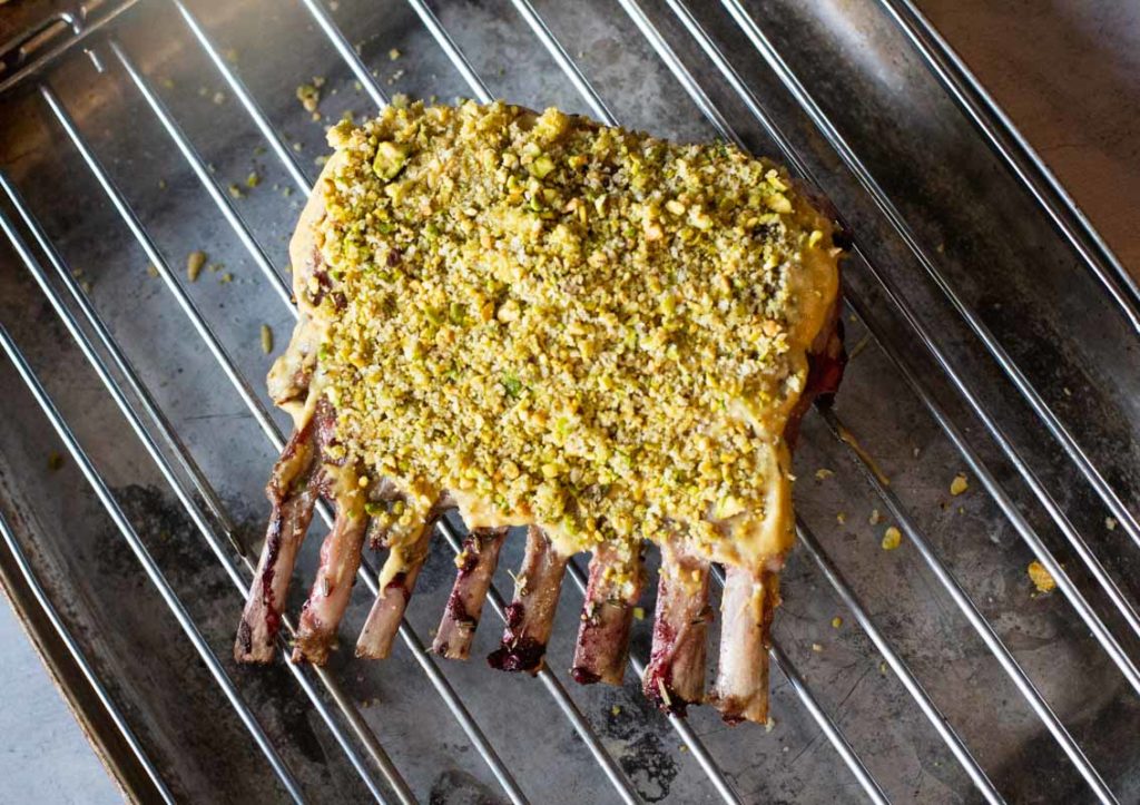 How to crust a rack of lamb with panko bread crumbs and pistachios.