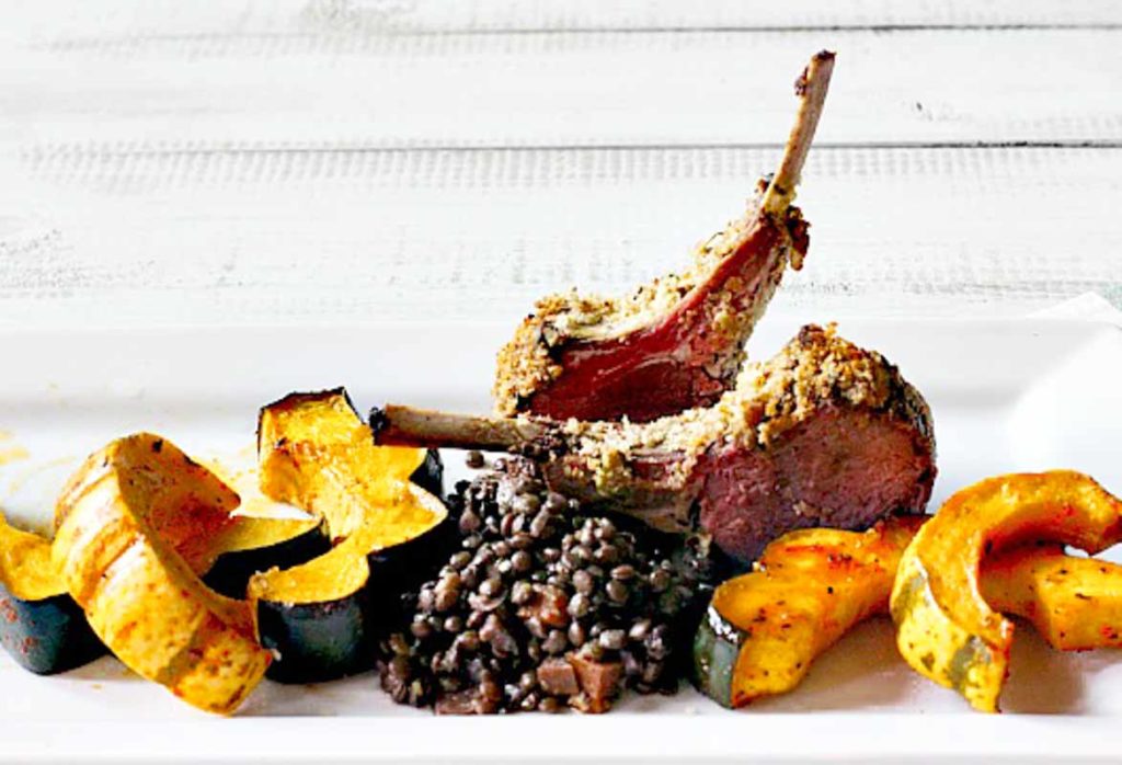 Two lamb chops served with lentils and roasted squash.