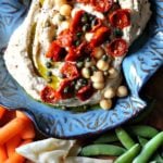 Homemade hummus topped with roasted cherry tomatoes.