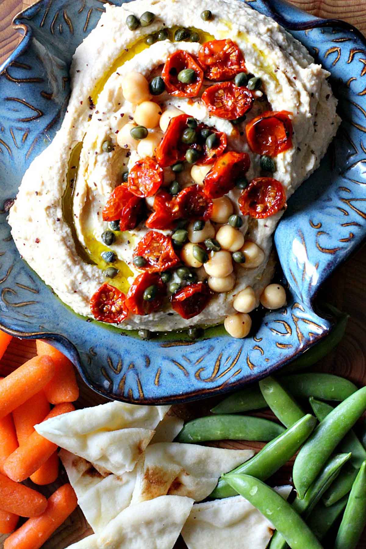 Homemade hummus topped with roasted cherry tomatoes.