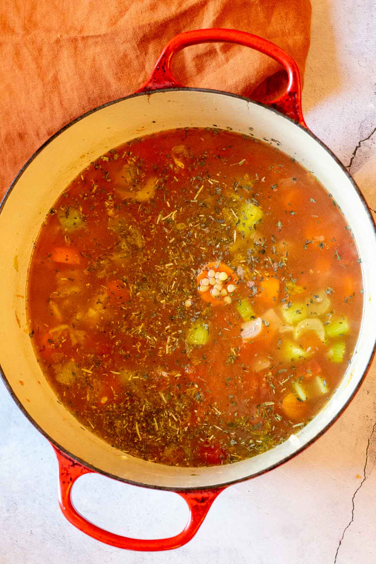 Adding broth to make lentil soup with turkey.