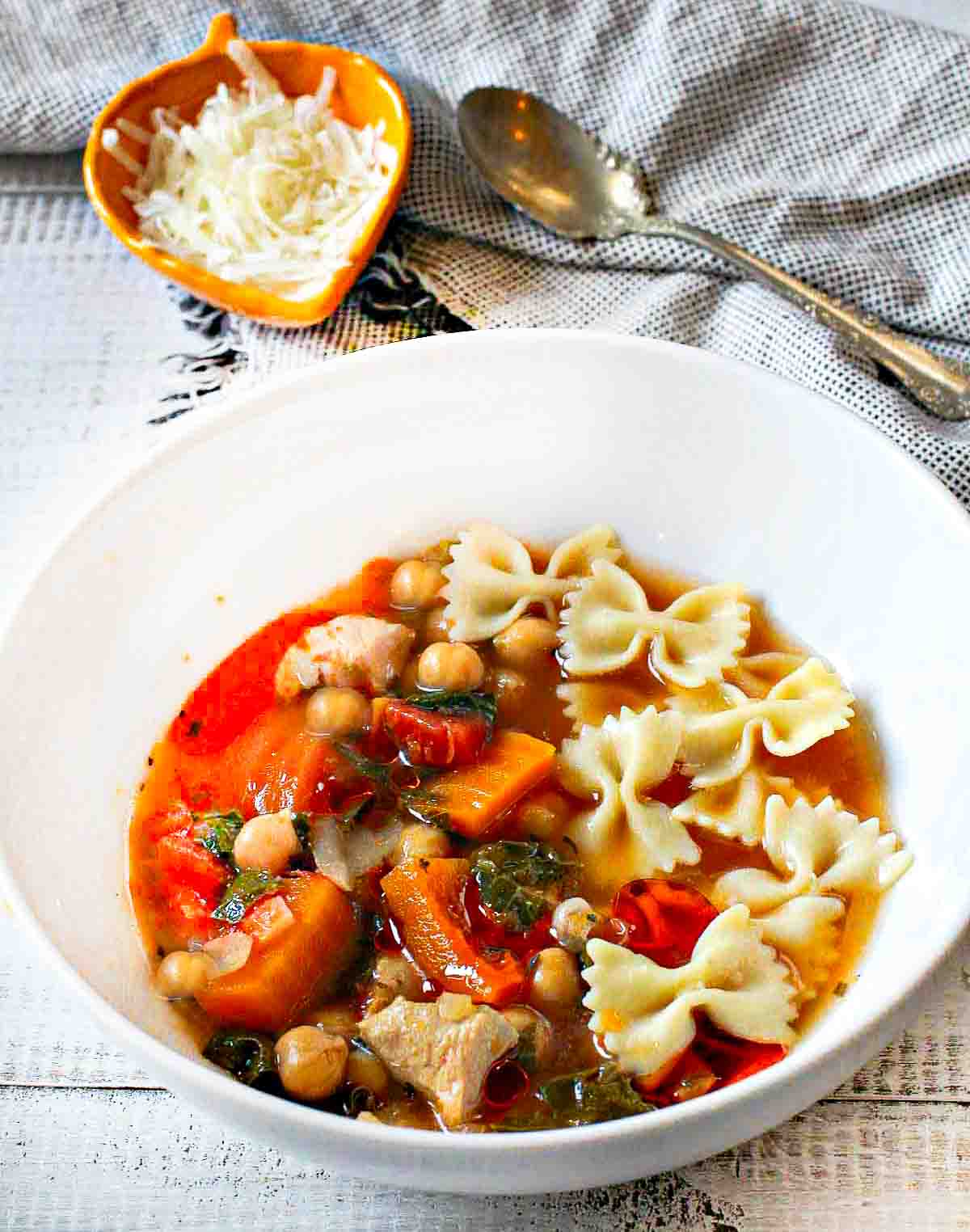 A bowl of Butternut Squash Soup with Chicken, chickpeas and pasta.