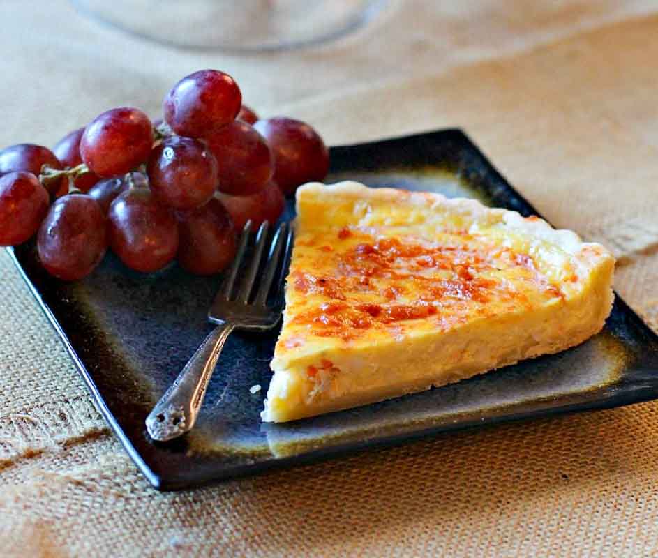 Crab quiche served with red grapes.