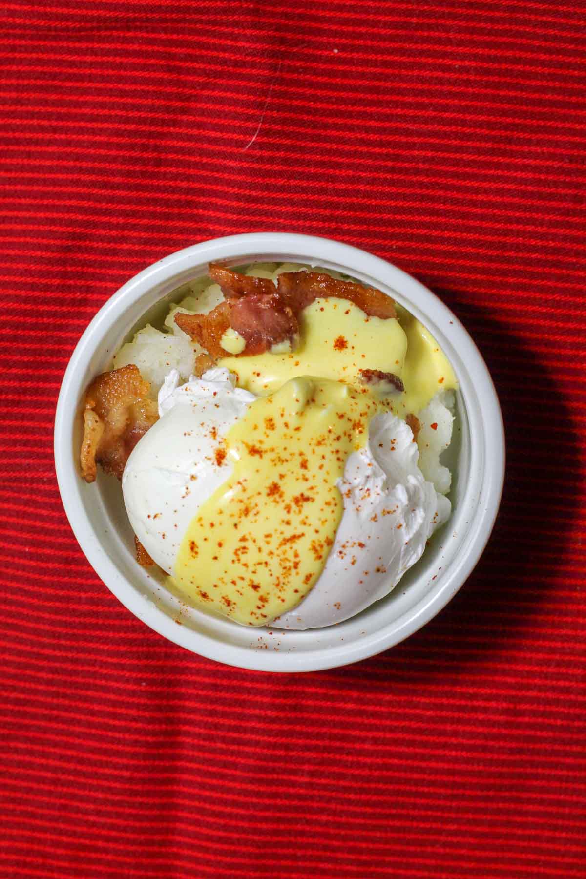 Mashed potato ramekins with poached eggs and hollandaise sauce.