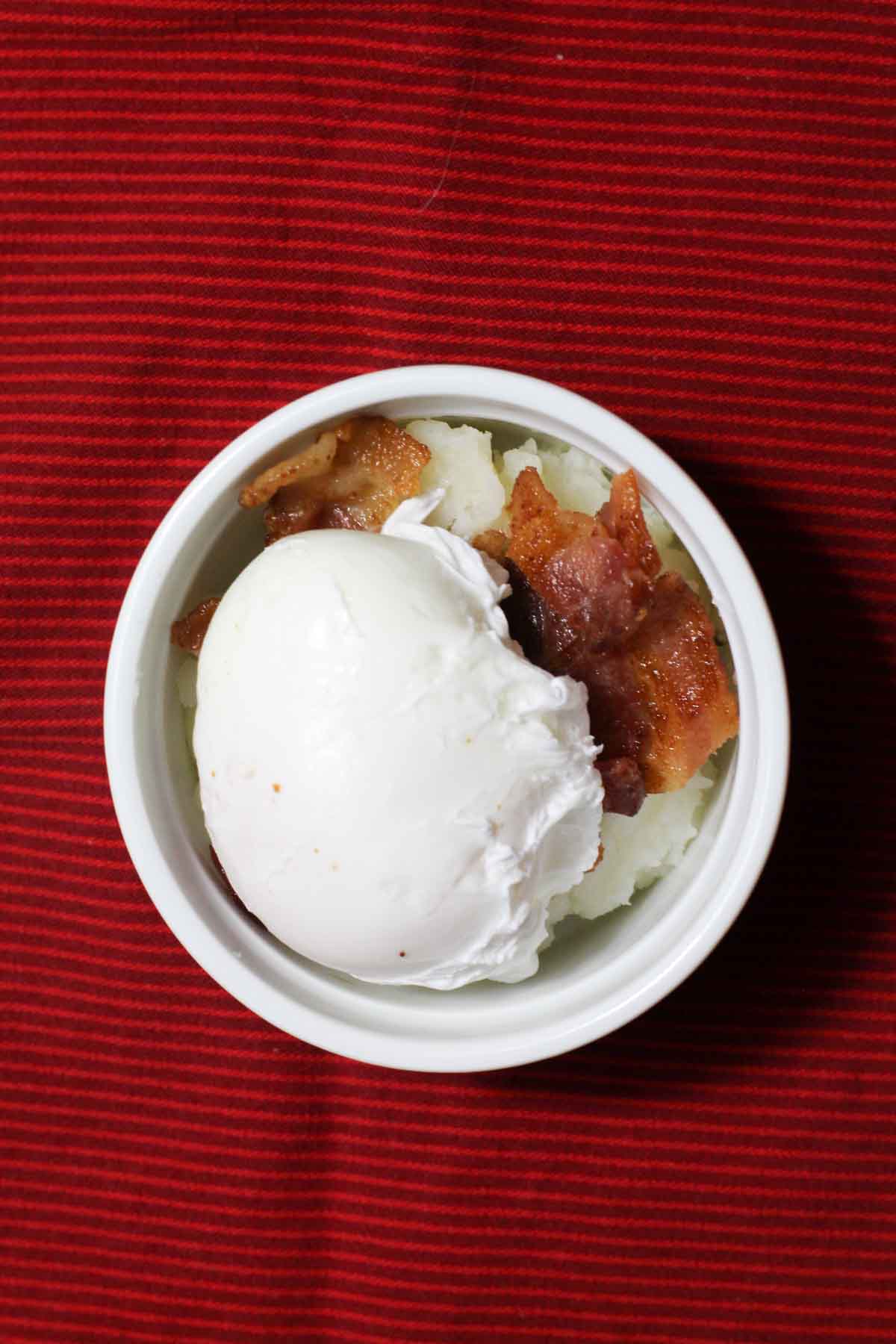 Mashed potatoes with bacon and poached eggs.