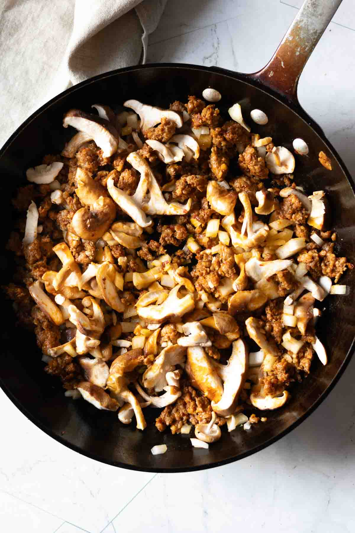 Browning chorizo and mushrooms to make chorizo tacos, step 2.
