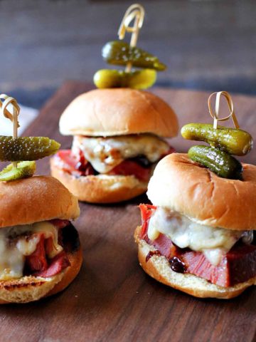 Instant Pot Corned Beef Sliders with melted Swiss cheese.