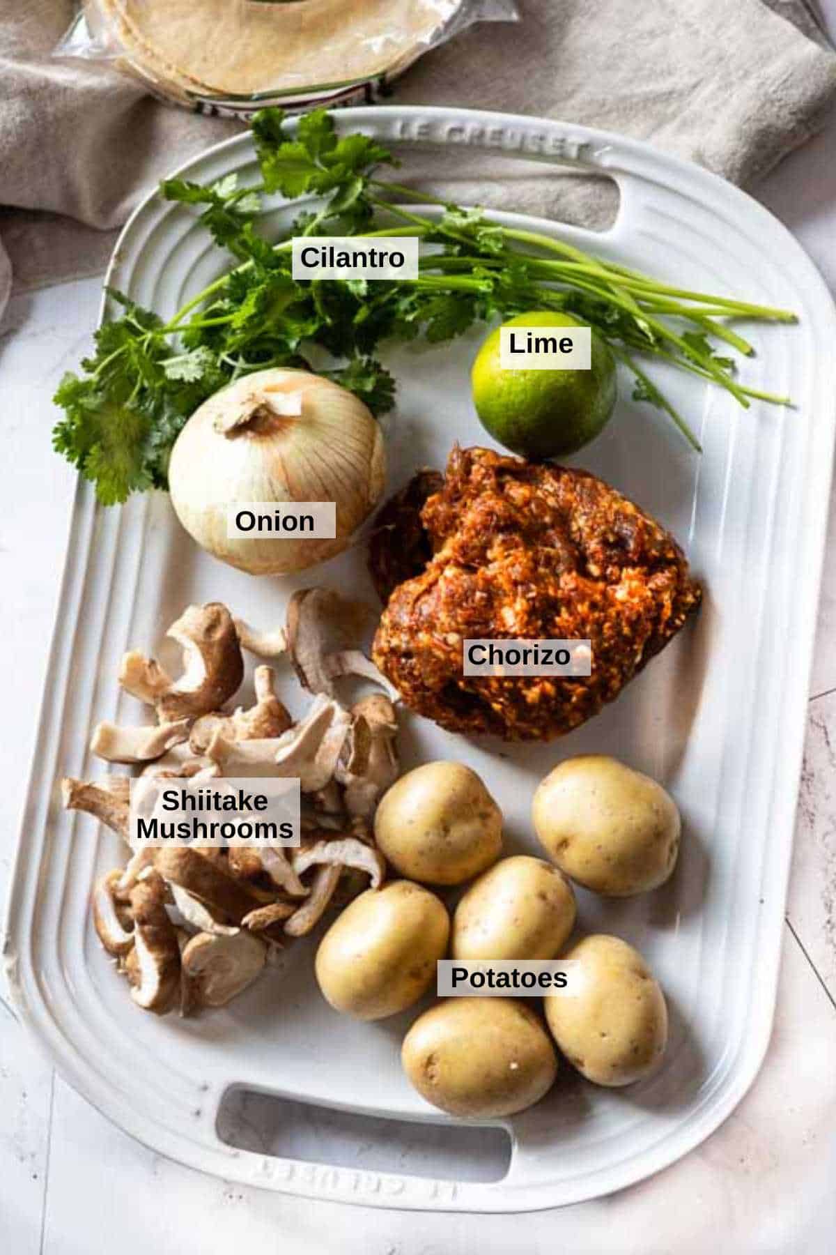 Ingredients to make chorizo tacos with potatoes and mushrooms.