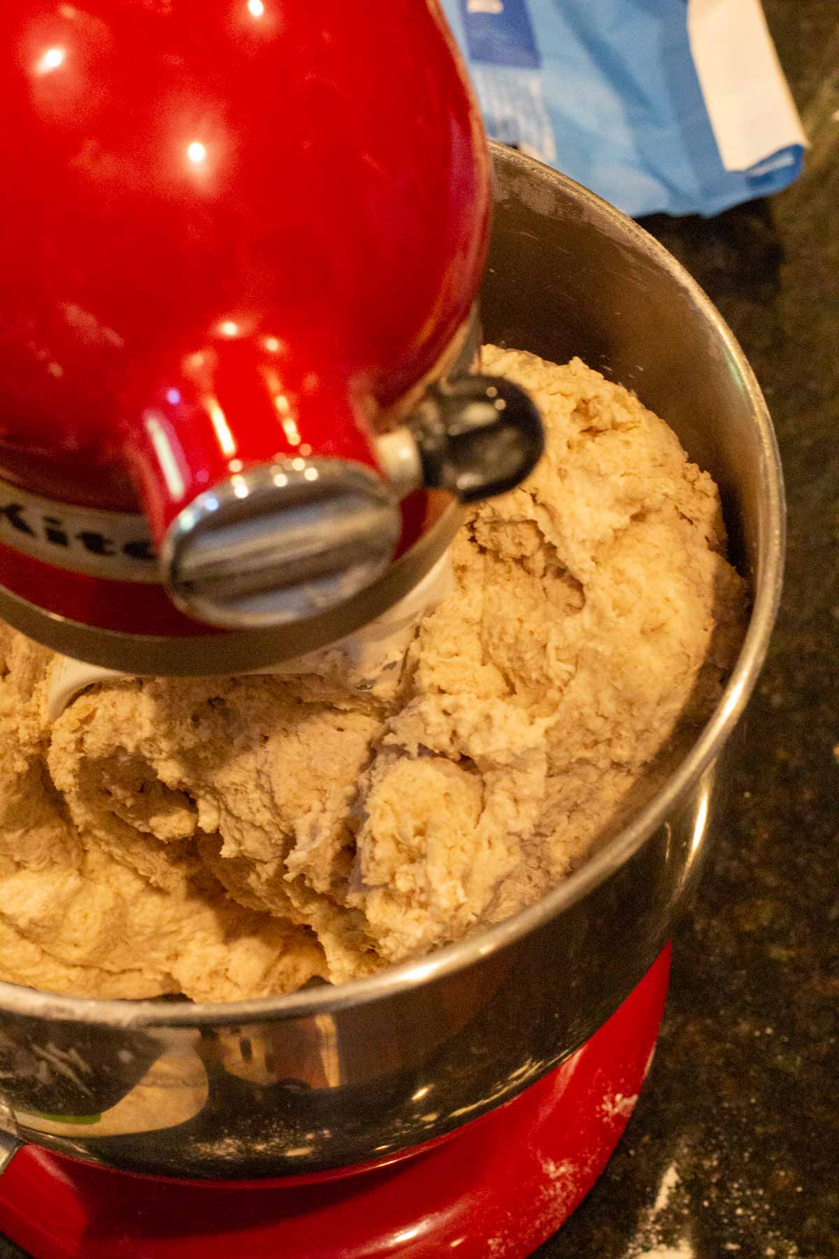 Mixing dough to make olive bread.