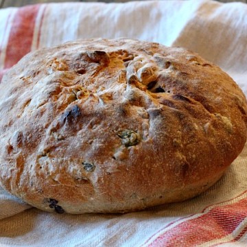 A loaf of Olive Rosemary bread. A beautiful homemade bread recipe. Salty olives, savory with rosemary. A nice crust and chewy on the inside.