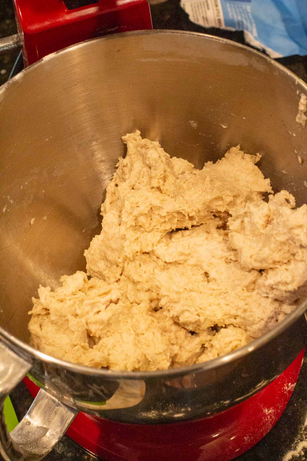 Olive bread dough that's been mixed to a shaggy mass state.