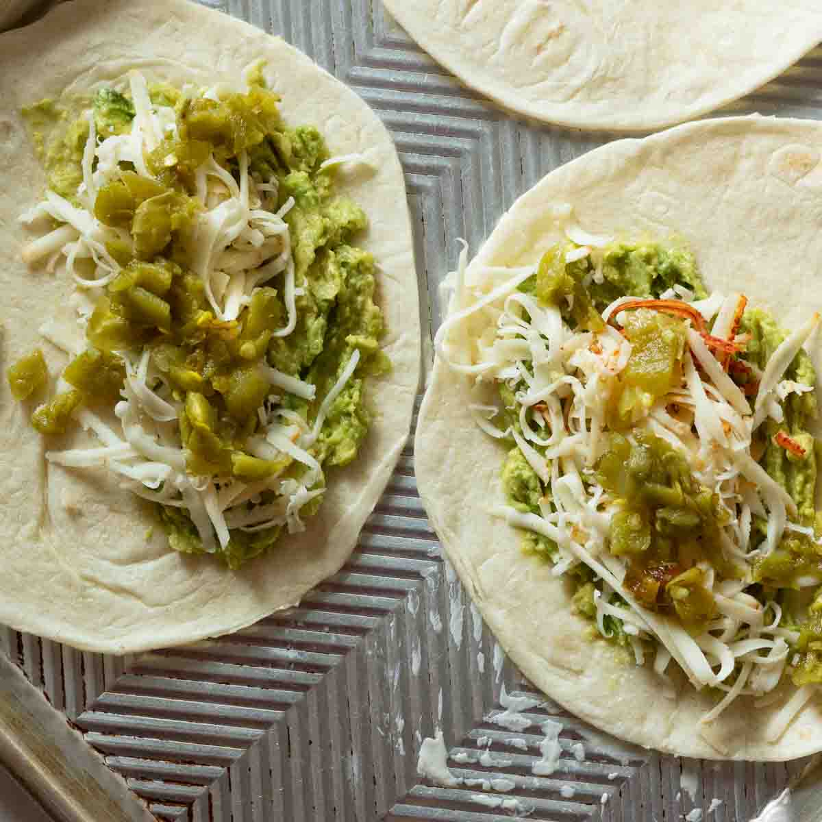 Adding green chile peppers to flour tortillas to make shrimp quesadillas.