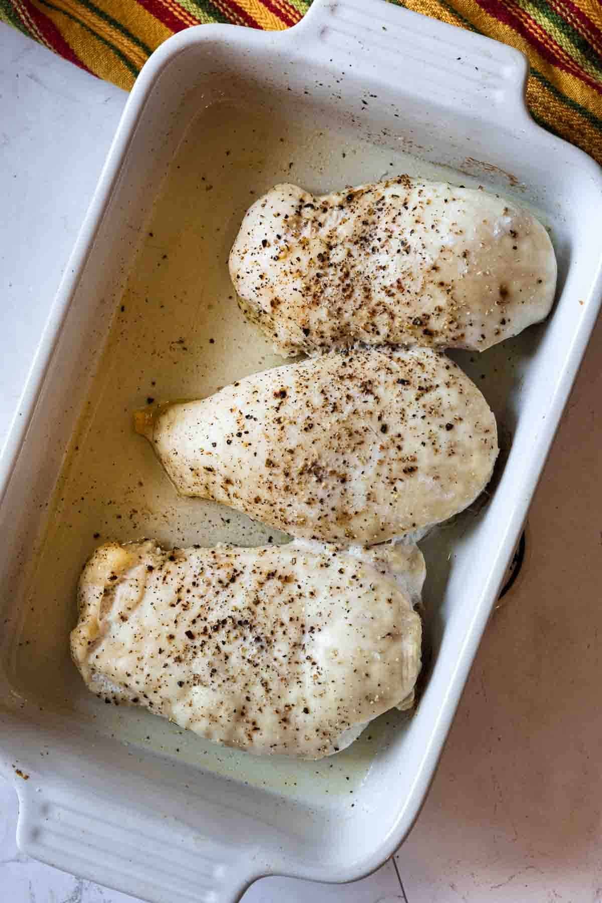 Cooking chicken breasts to make chipotle mac and cheese with chicken.