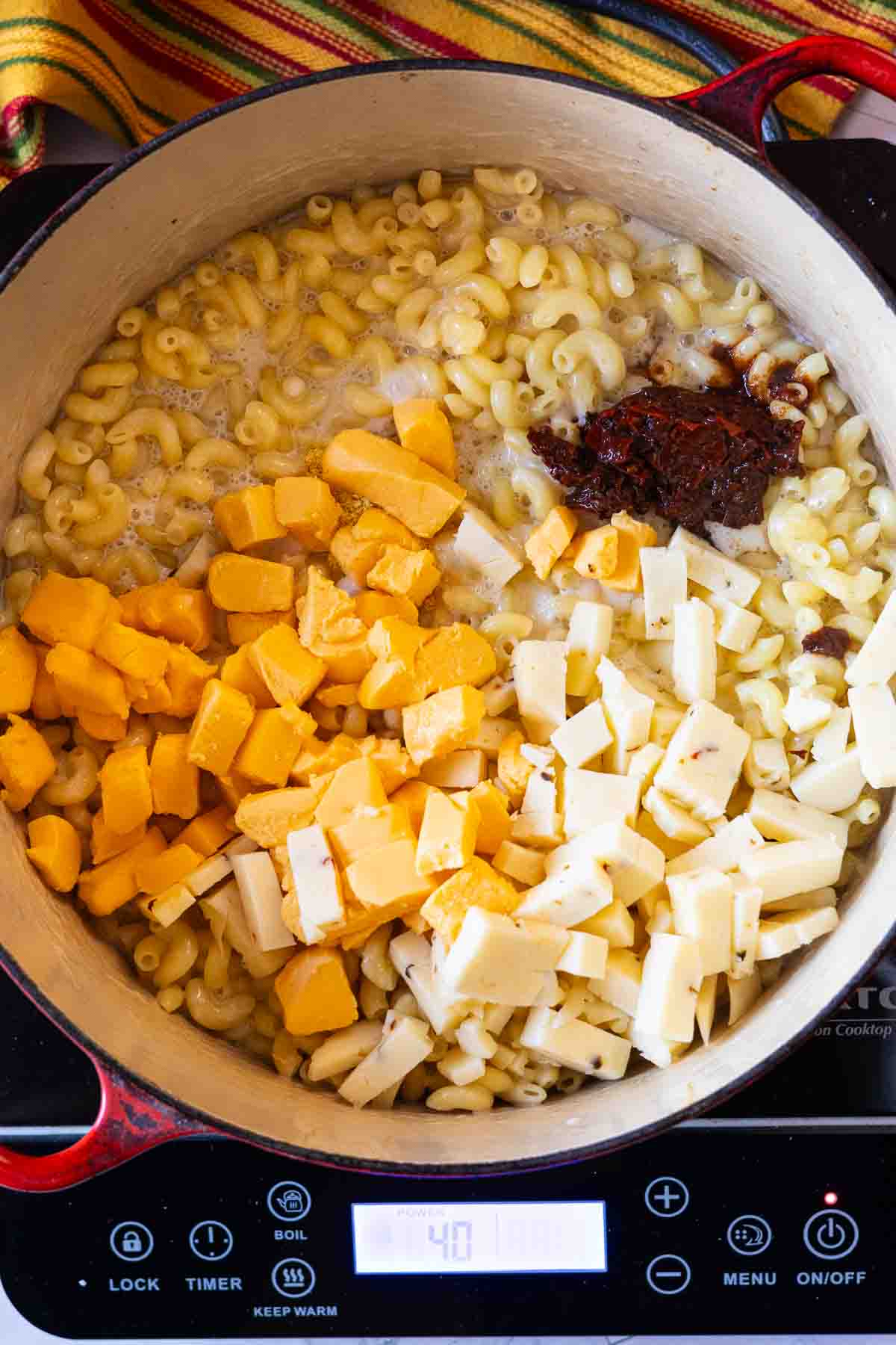 Step 5: Adding cheese and chipotle peppers to make macaroni and cheese with chicken.