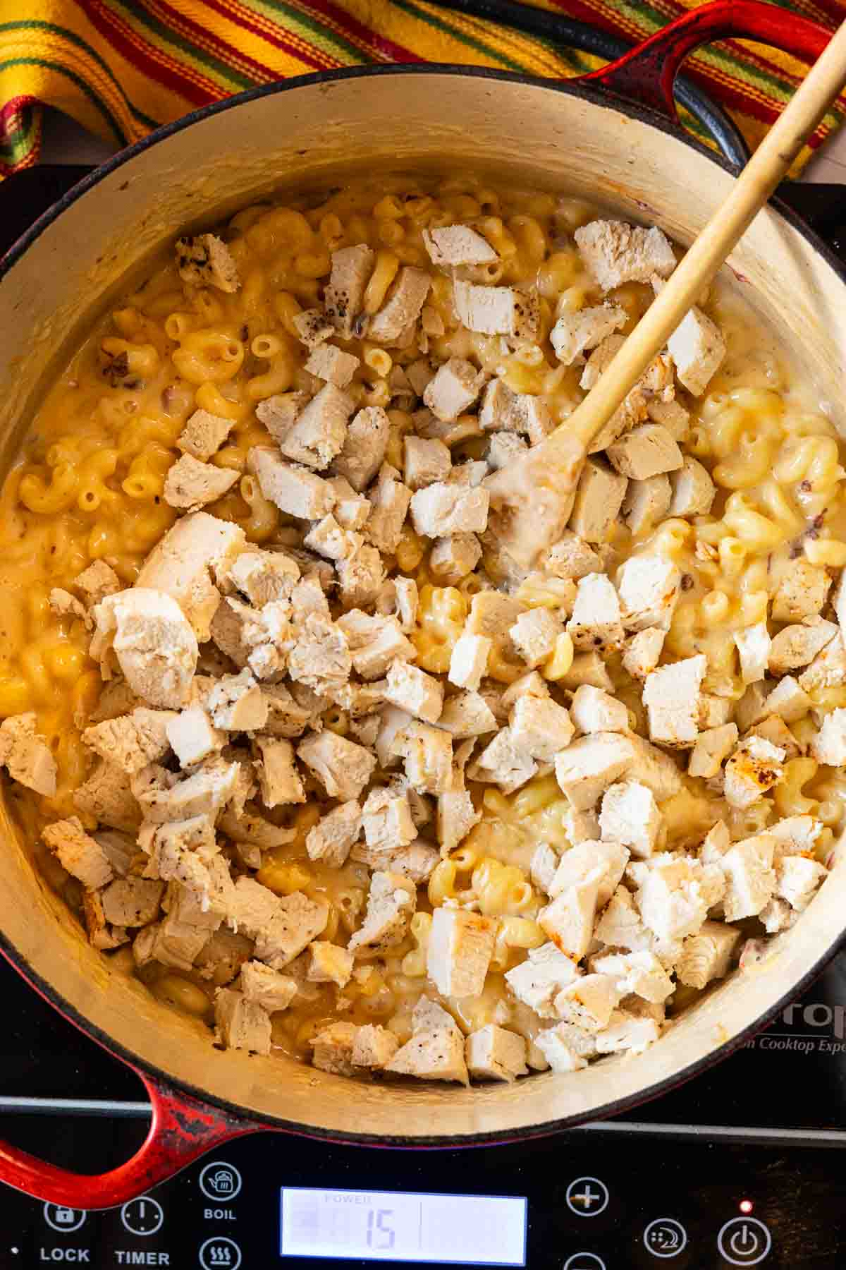 Step 6: Adding chicken to cooked macaroni and cheese.