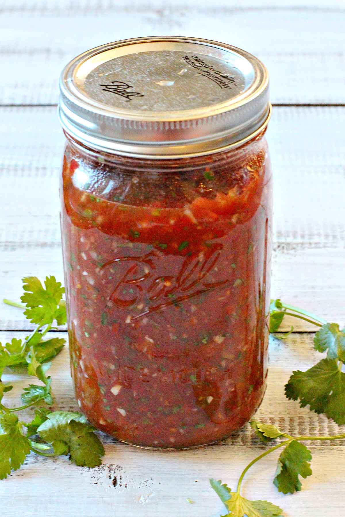 A jar of homemade restaurant style mexican salsa.