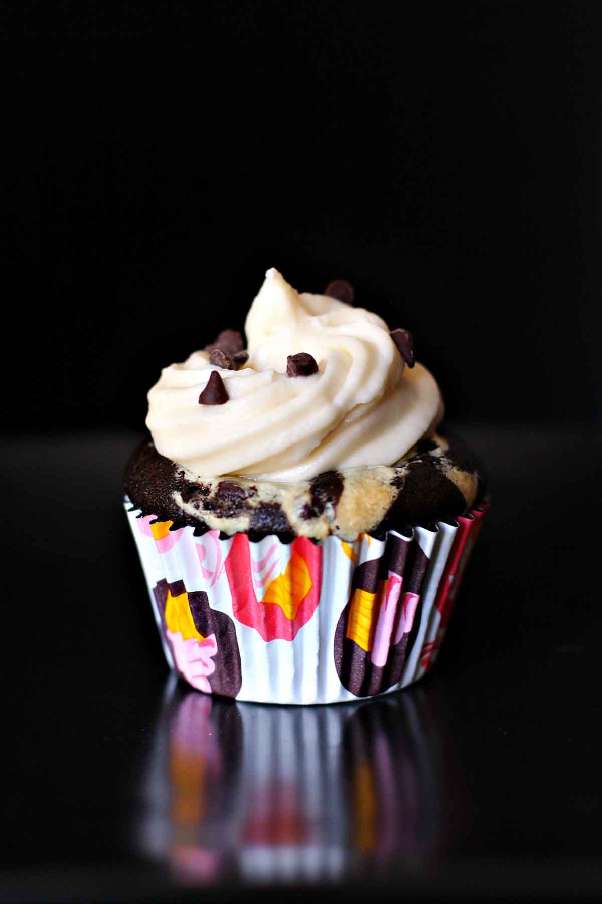 Chocolate black bottom cupcake with white frosting.