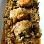 One pan crispy chicken thigh dinner sitting in a tomatillo lime sauce on a white serving platter