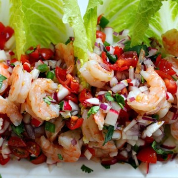 Shrimp tacos with tomatoes, radish, red onion on romaine lettuce with lime dressing