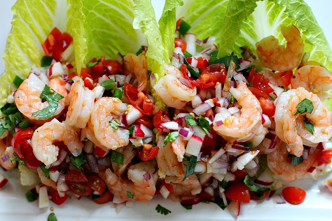 Shrimp tacos with tomatoes, radish, red onion on romaine lettuce with lime dressing