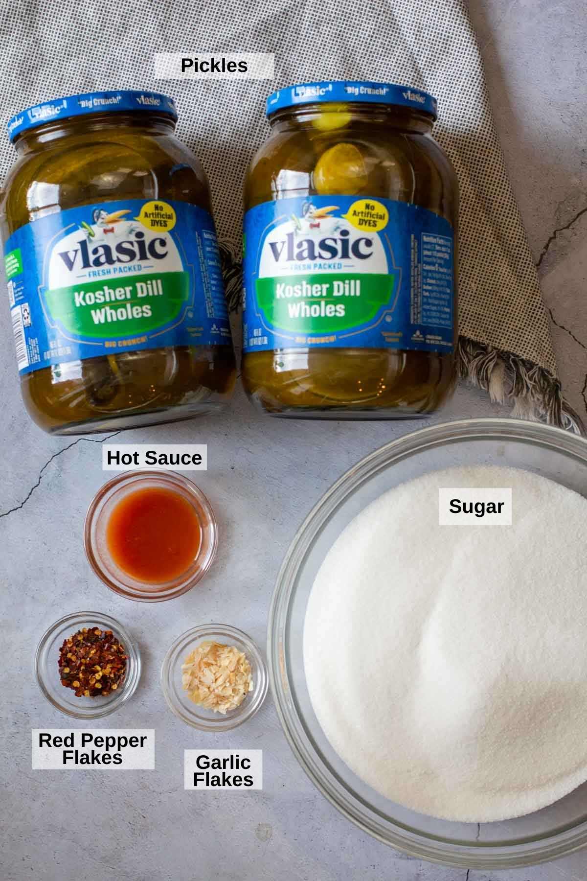 Ingredients to make spicy pickles from jarred dill pickles.