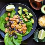 Mexican salad recipe served on bibb lettuce and topped with chicken, kidney beans, sweet corn, olives and avocado