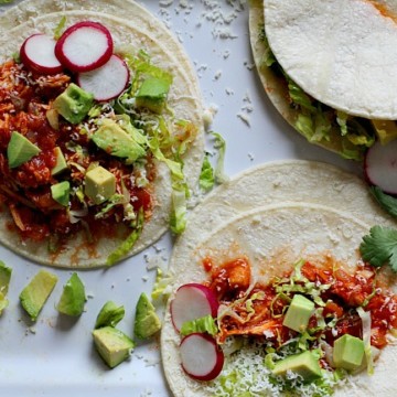 Warm flour tortillas filled with chicken and topped with romaine lettuce, radishes and avocado for chicken soft tacos.