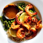 The best grilled shrimp recipe served with asparagus peas and brown rice with a bowl of butter sauce