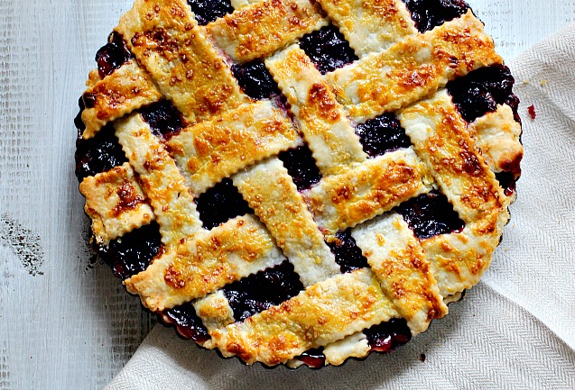 Fresh cherry pie with homemade lattice pie crust in a 9 inch tart pan.