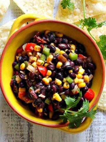 Black bean corn salsa dip in a yellow bowl.