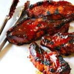 Grilled country style pork ribs with BBQ sauce.