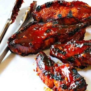 Grilled country style pork ribs with BBQ sauce.